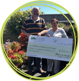 Jenny and Alan King in their beautiful garden with a cheque for CHSW